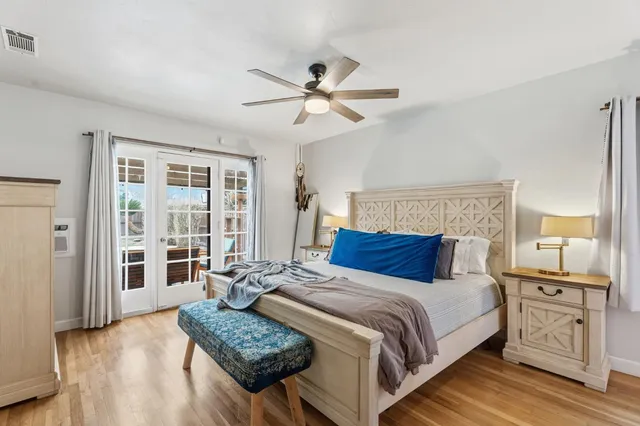 a bedroom with a large bed and a window