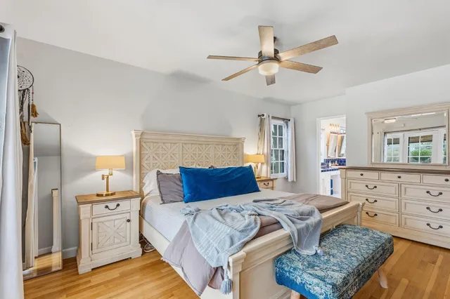 a bedroom with a bed and ceiling fan