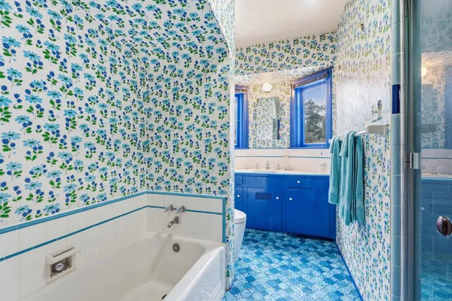 a bathroom with a bathtub and shower