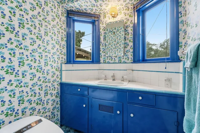 a bathroom with a sink a toilet and a mirror