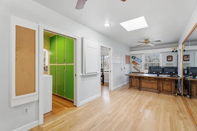 a view of a living room with kitchen and furniture