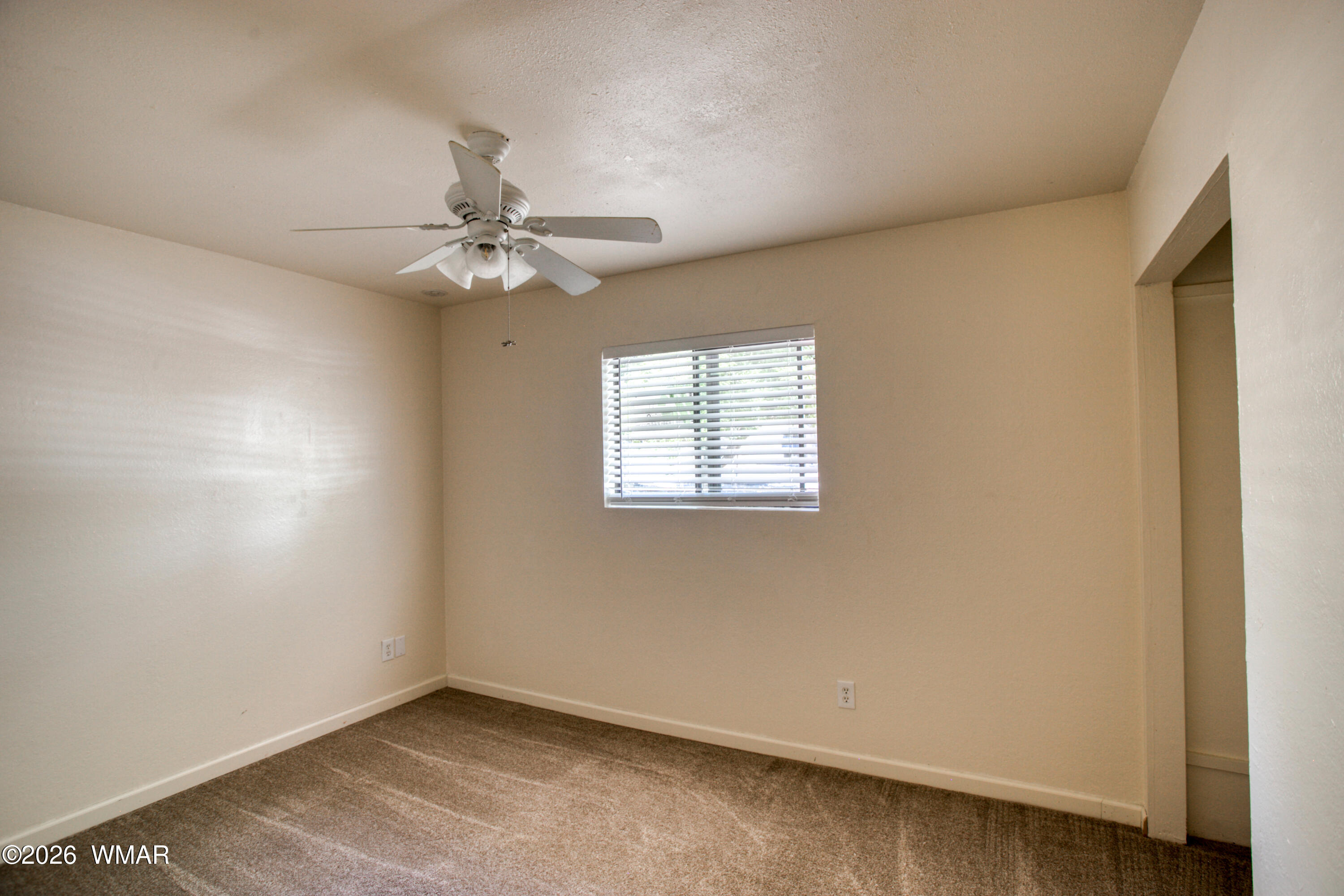 411 West Stratton Show Low, AZ 85901 - Photo 16 of 47 an empty room with a window and a ceiling fan