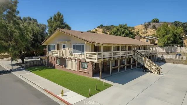 a view of a house with a backyard and a patio