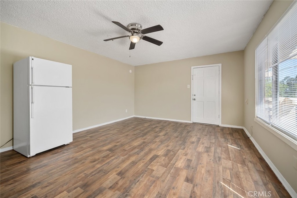 3505 Spring Street Paso Robles, CA 93446 - Photo 8 of 19 an empty room with wooden floor fan and windows