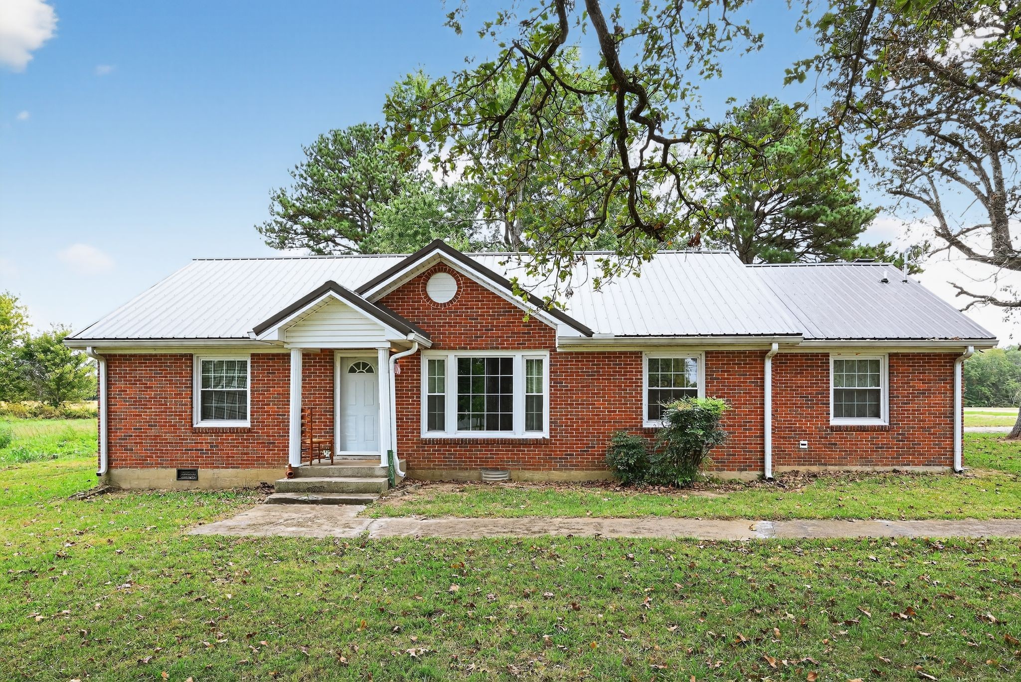 a front view of a house with a garden