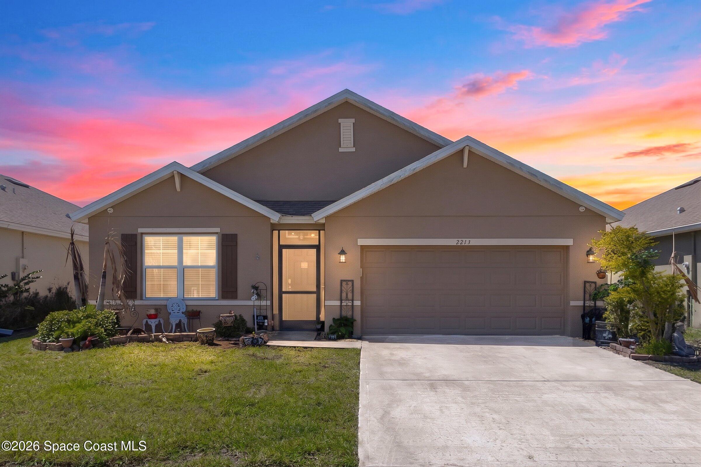 2213 McCormack Way Melbourne, FL 32935 - Photo 1 of 73 a front view of house with yard and trees