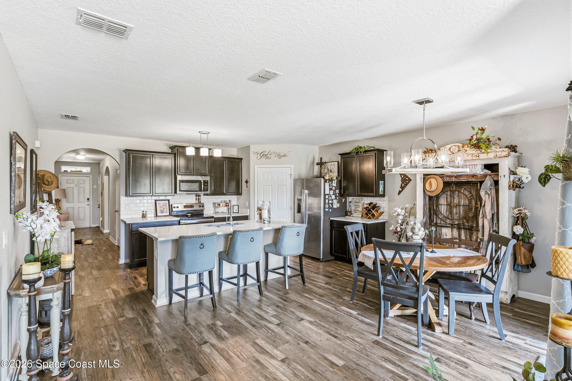 2213 McCormack Way Melbourne, FL 32935 - Photo 13 of 73 a view of a dining room with furniture and wooden floor