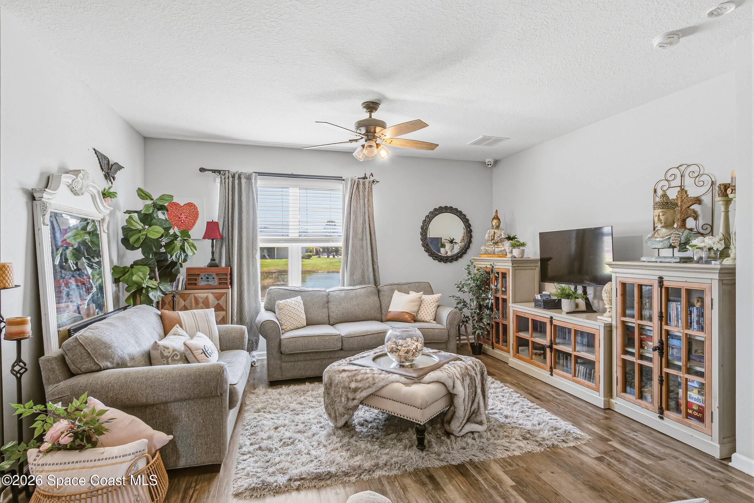 2213 McCormack Way Melbourne, FL 32935 - Photo 17 of 73 a living room with furniture a rug and a flat screen tv