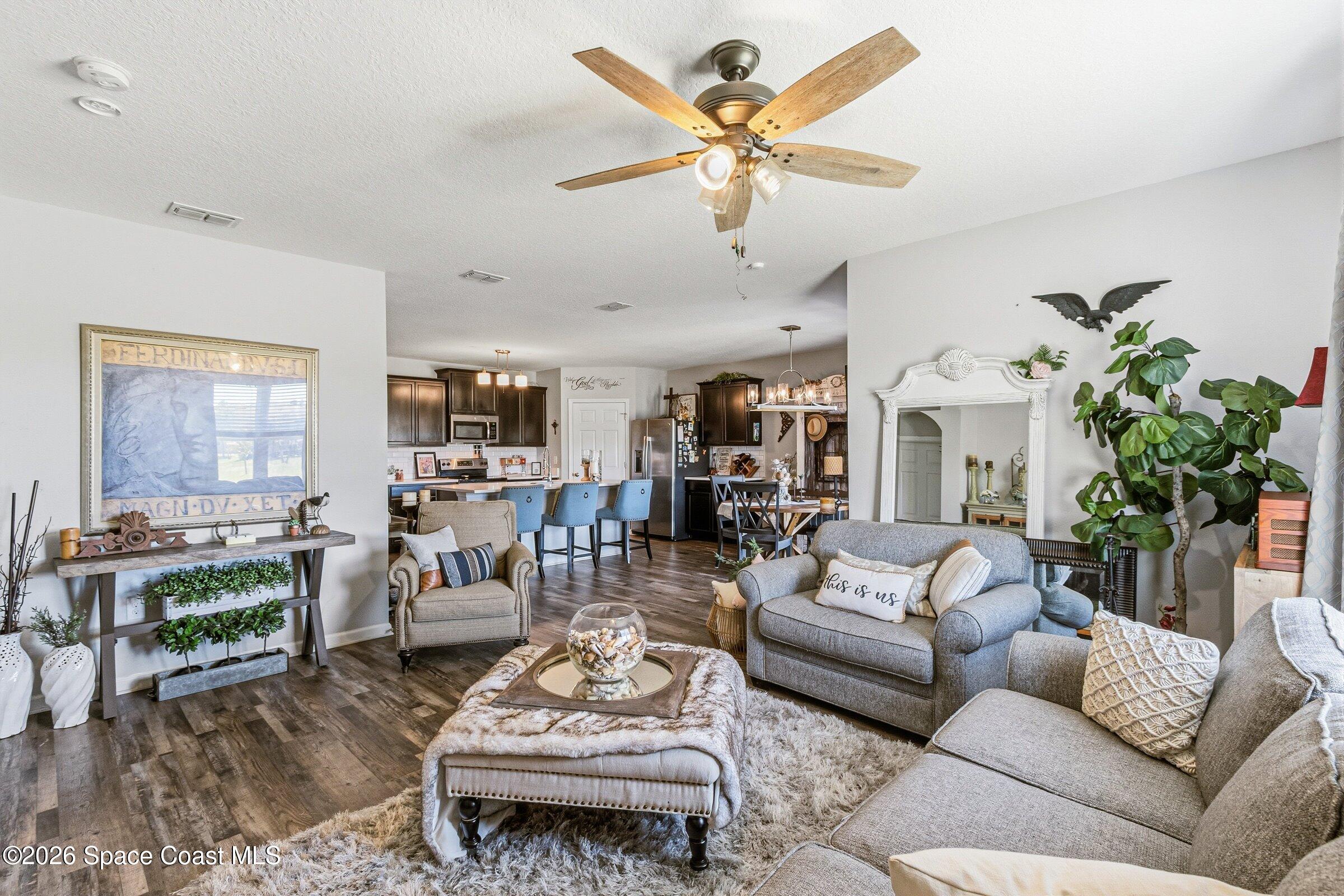 2213 McCormack Way Melbourne, FL 32935 - Photo 18 of 73 a living room with furniture kitchen view and a large window