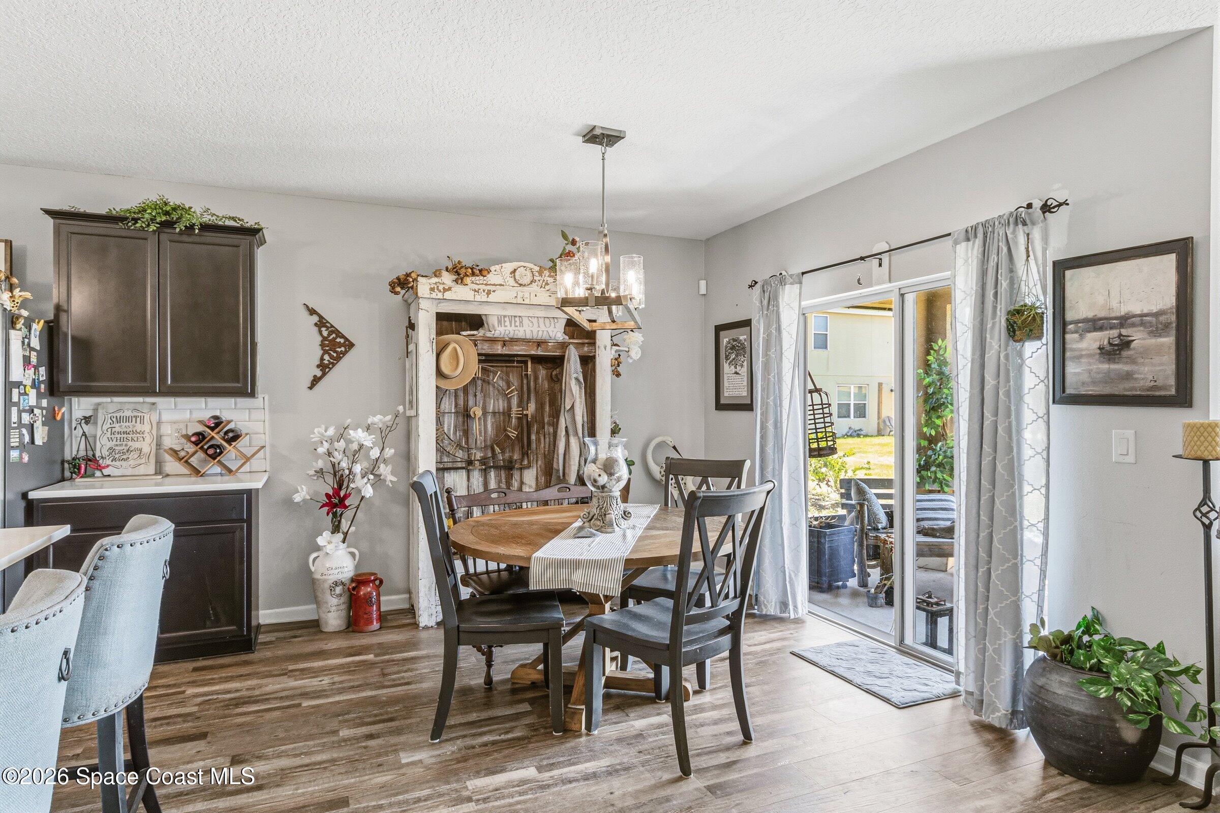 2213 McCormack Way Melbourne, FL 32935 - Photo 21 of 73 a view of a dining room with furniture and chandelier