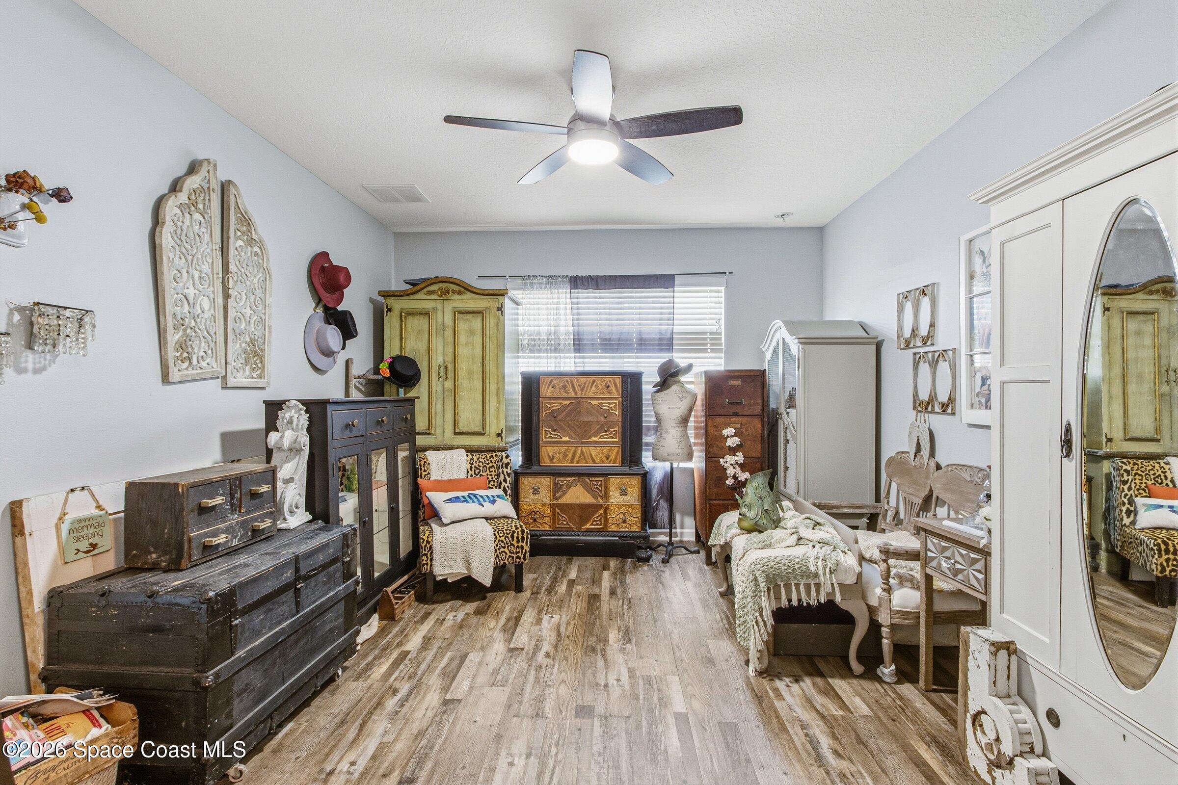 2213 McCormack Way Melbourne, FL 32935 - Photo 24 of 73 a living room with furniture and a wooden floor