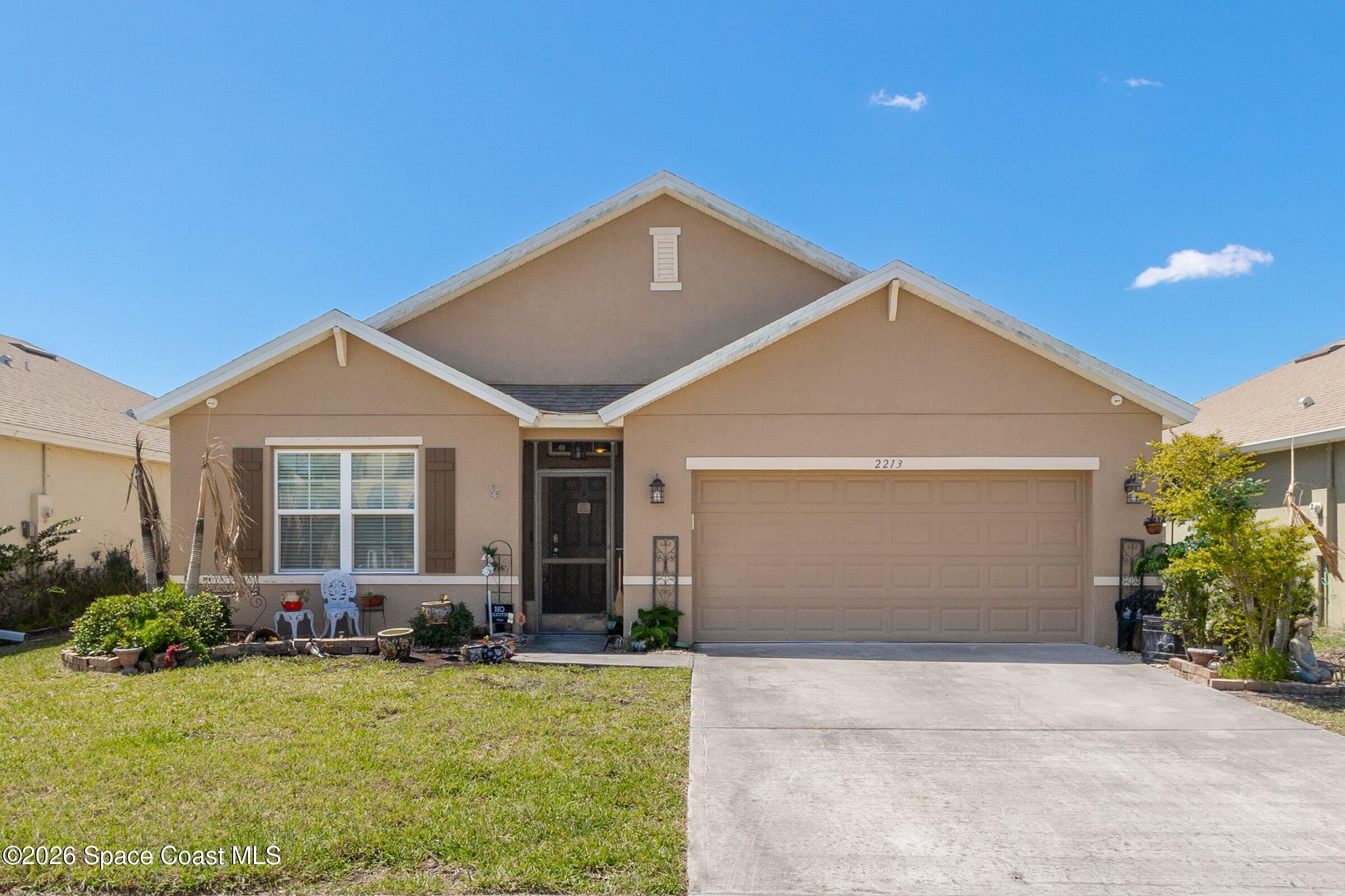 2213 McCormack Way Melbourne, FL 32935 - Photo 3 of 73 a front view of house with yard and porch