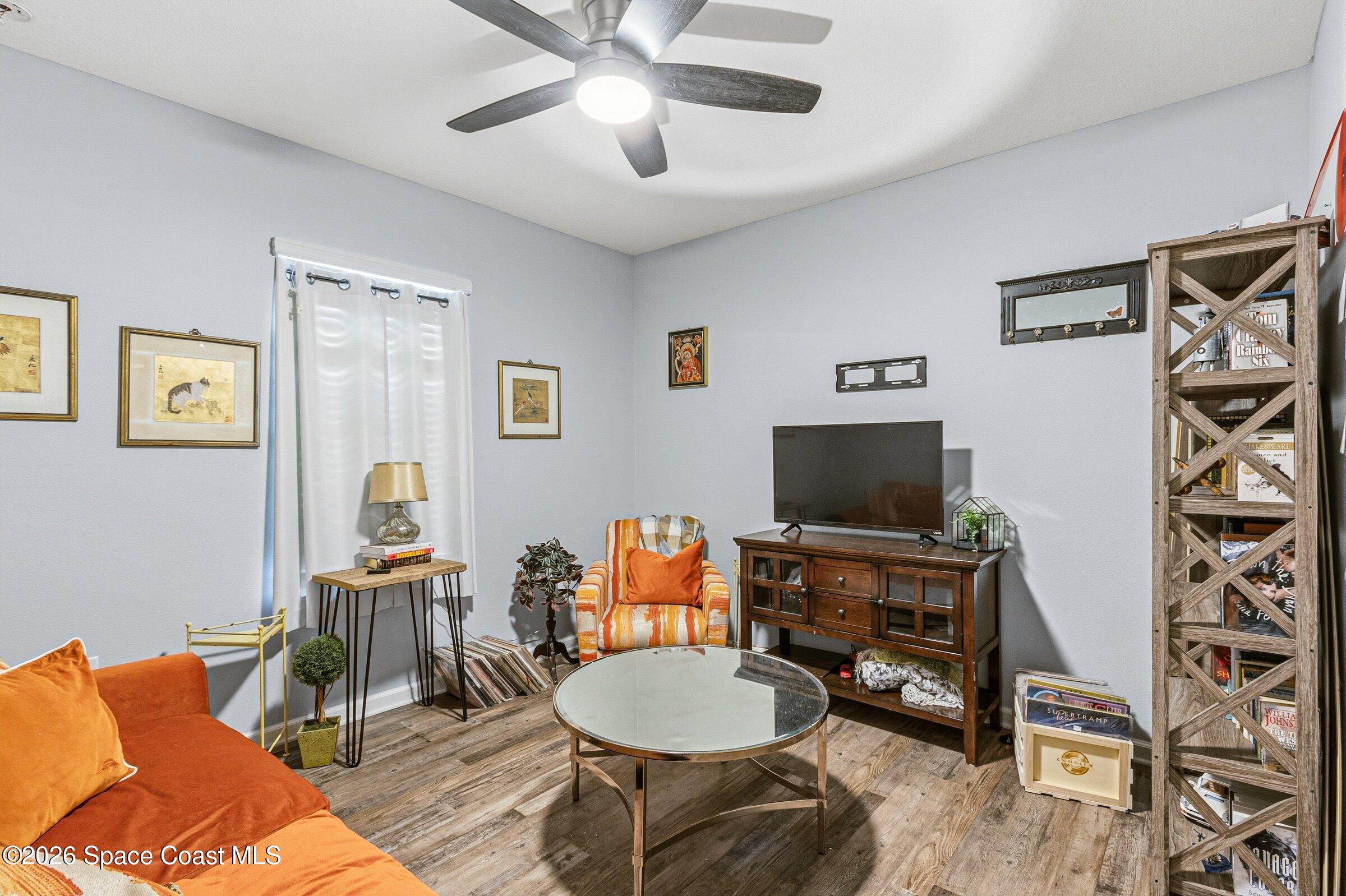 2213 McCormack Way Melbourne, FL 32935 - Photo 31 of 73 a living room with furniture and a flat screen tv
