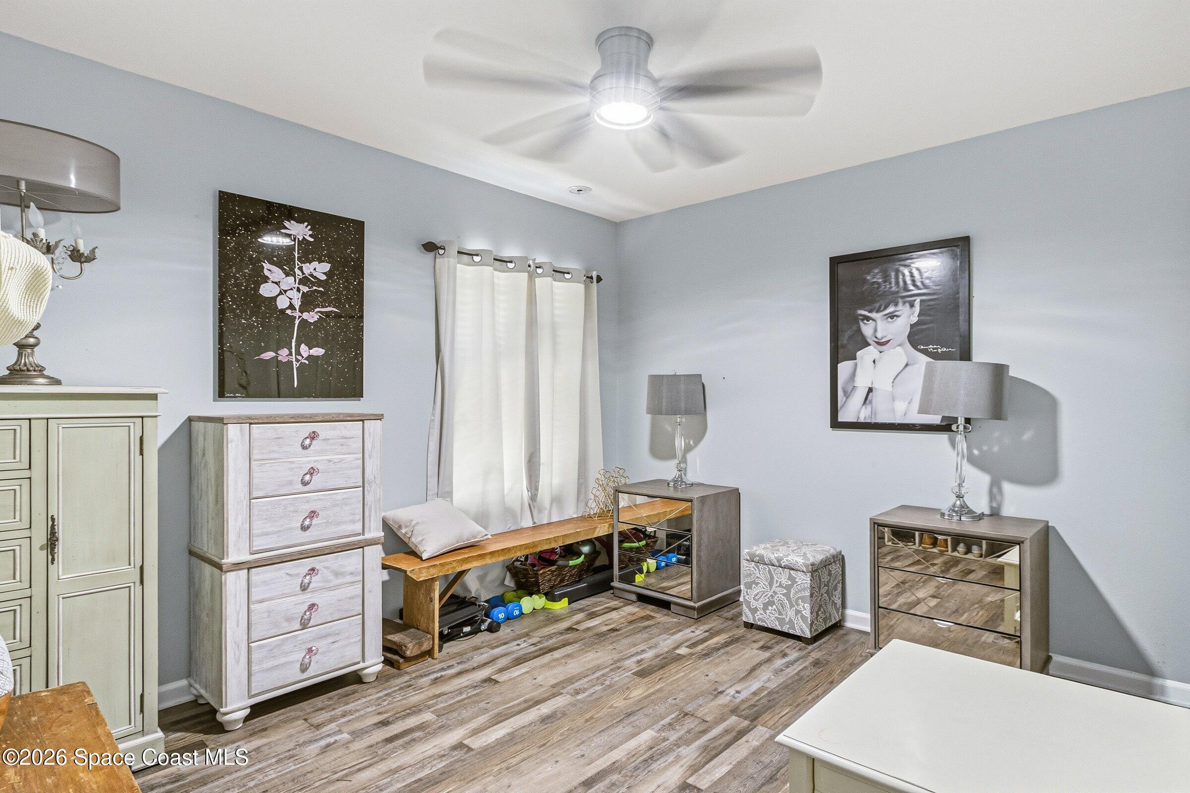 2213 McCormack Way Melbourne, FL 32935 - Photo 32 of 73 a bedroom with furniture and wooden floor
