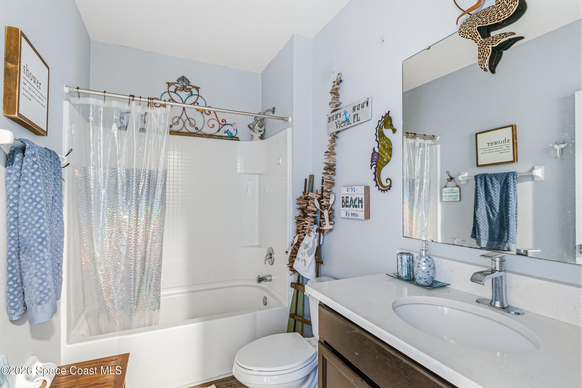 2213 McCormack Way Melbourne, FL 32935 - Photo 33 of 73 a bathroom with a sink toilet and shower