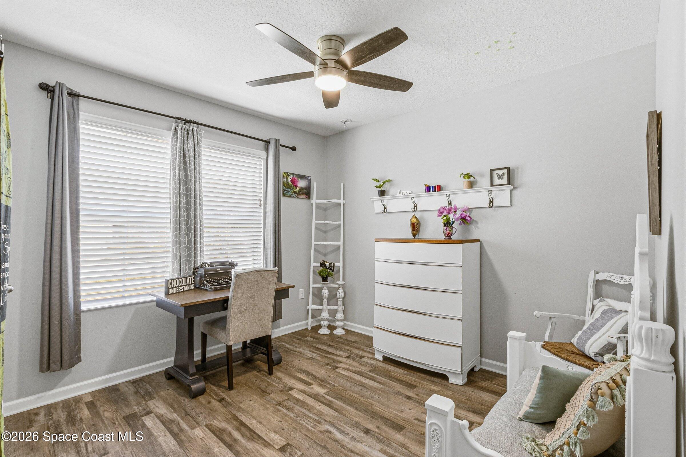 2213 McCormack Way Melbourne, FL 32935 - Photo 34 of 73 a room that has a bed and a chair in it