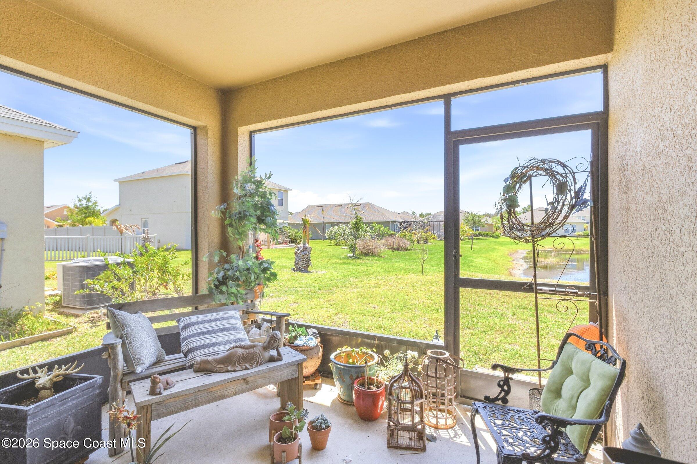 2213 McCormack Way Melbourne, FL 32935 - Photo 36 of 73 a living room with furniture and floor to ceiling windows