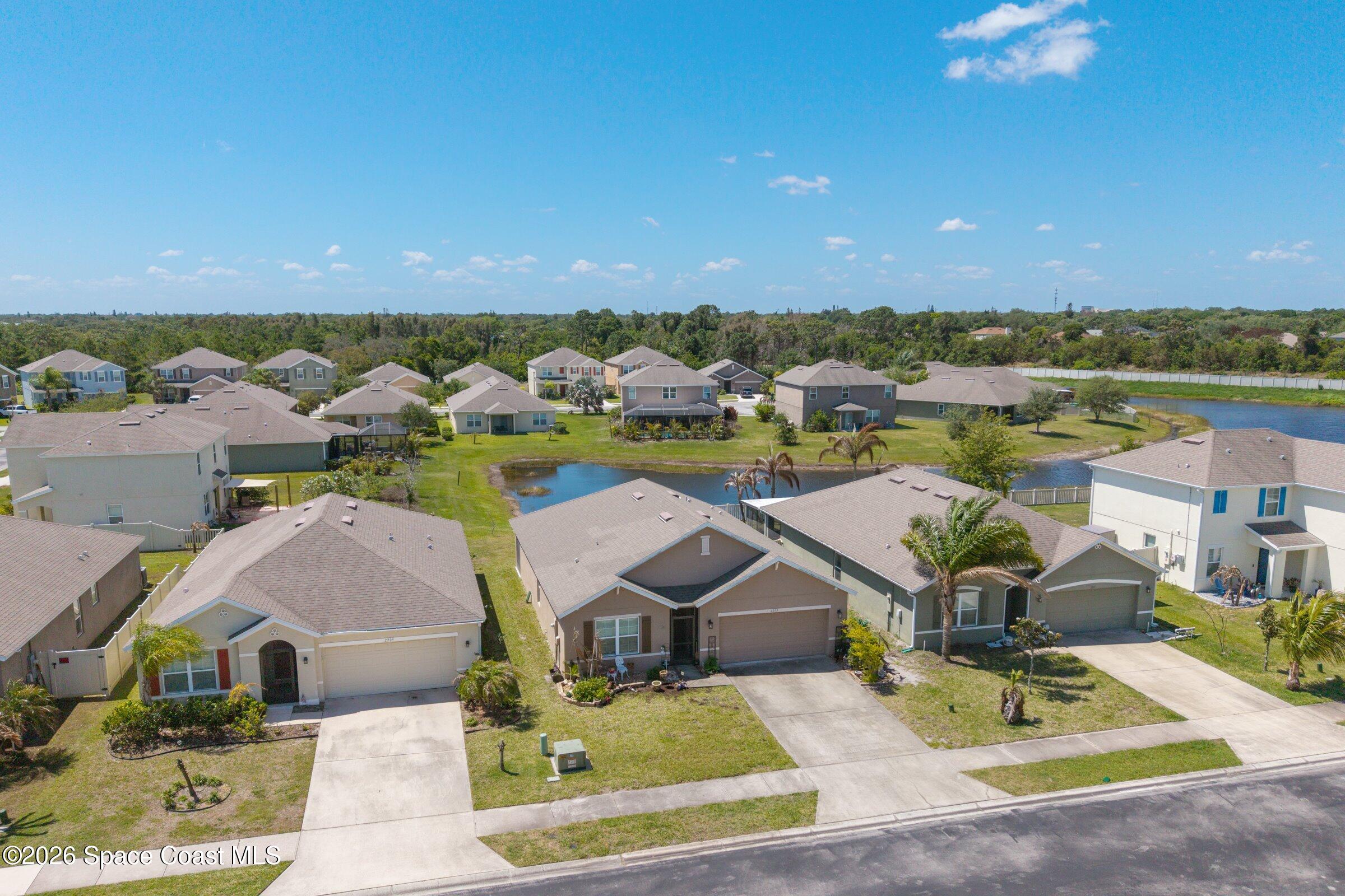 2213 McCormack Way Melbourne, FL 32935 - Photo 40 of 73 an aerial view of a house with outdoor space