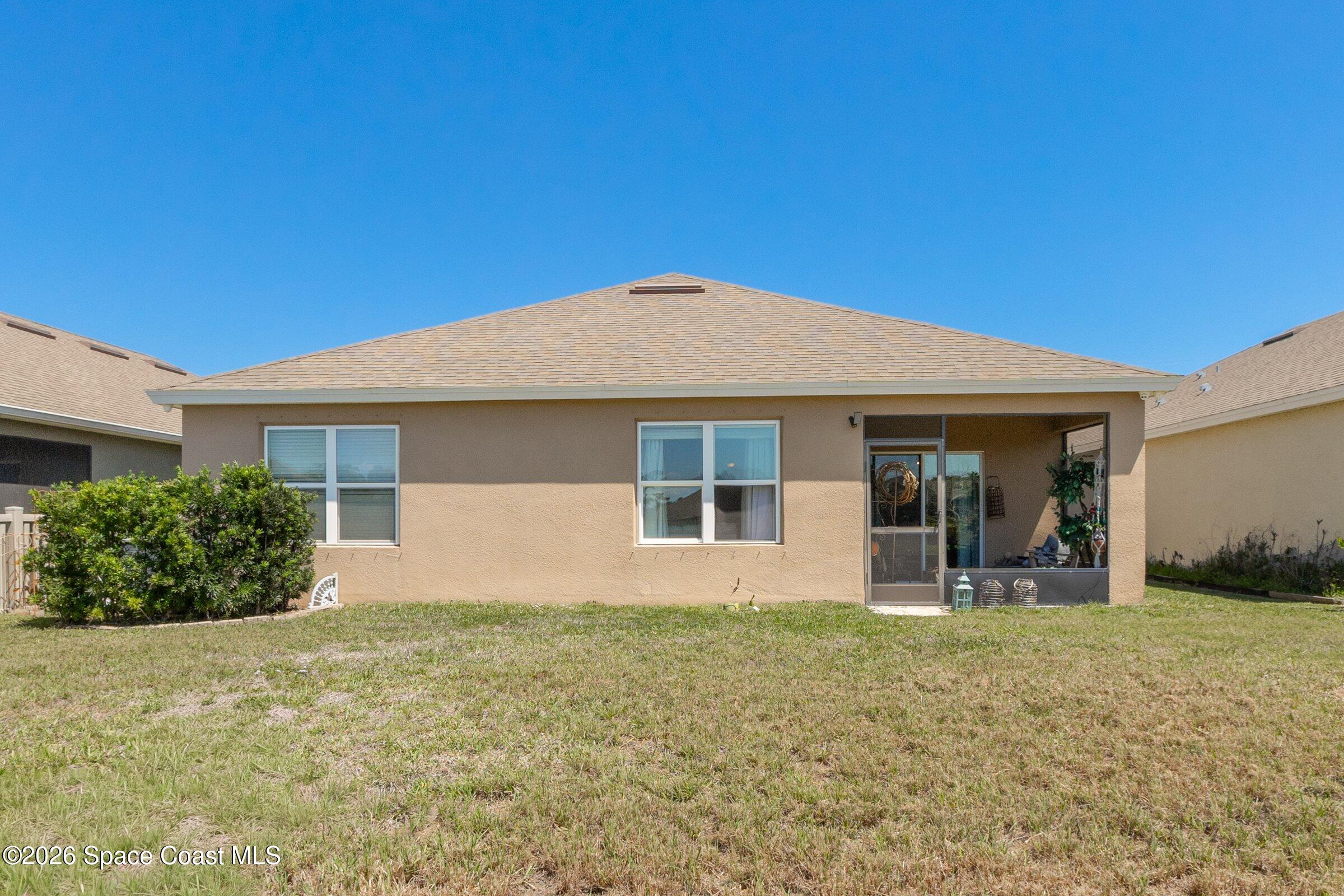 2213 McCormack Way Melbourne, FL 32935 - Photo 5 of 73 a front view of a house with garden