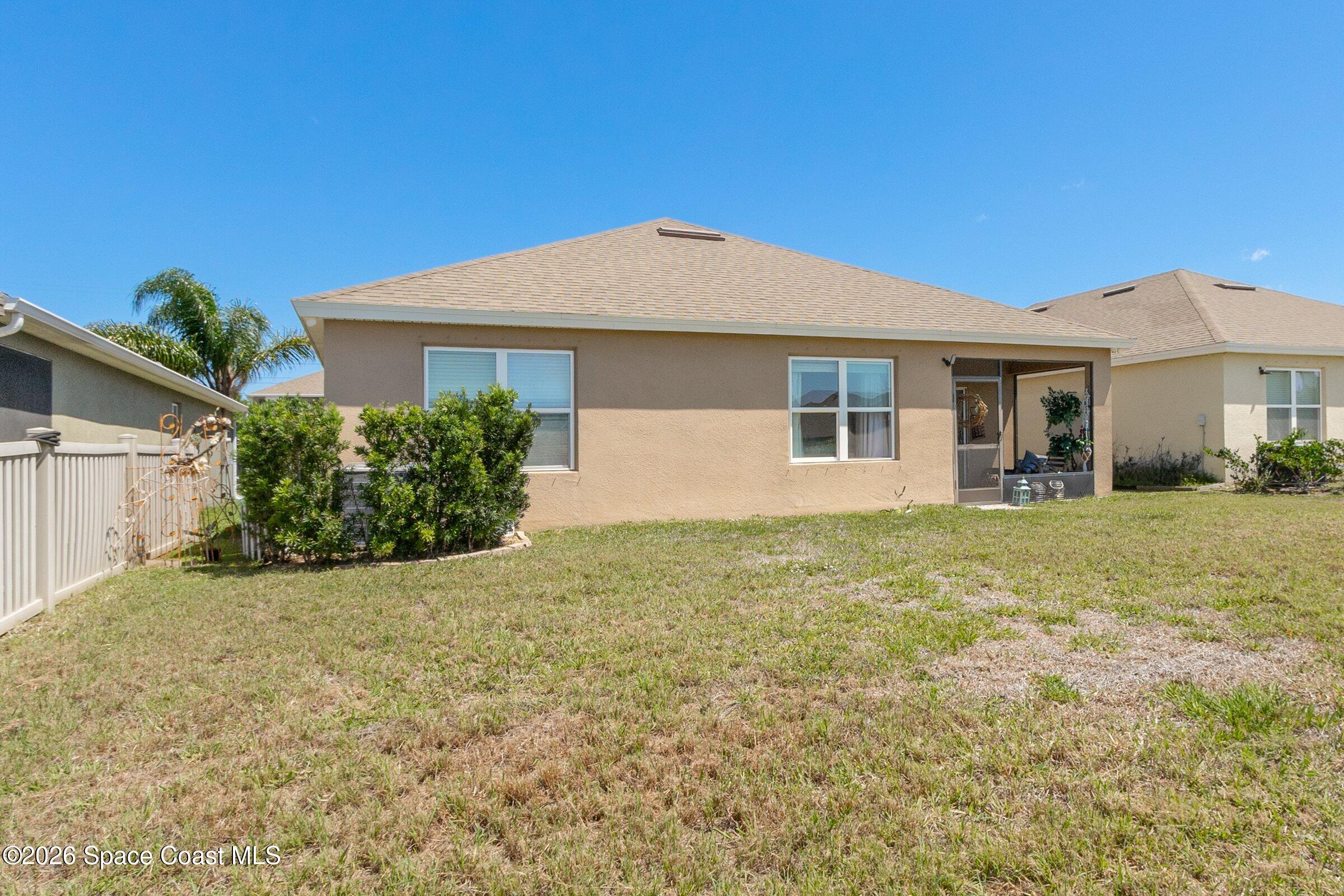 2213 McCormack Way Melbourne, FL 32935 - Photo 6 of 73 a front view of a house with garden
