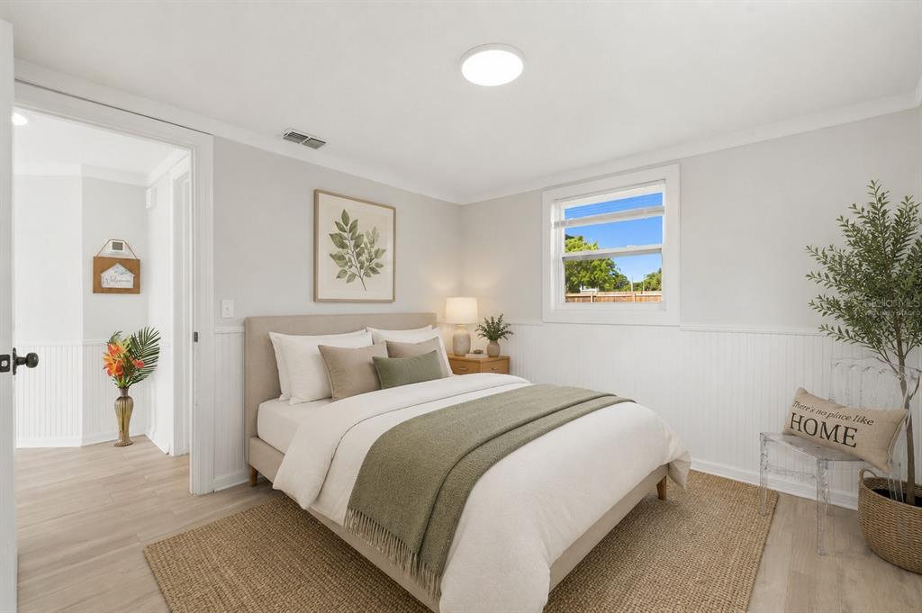 9033 Pegasus Avenue Port Richey, FL 34668 - Photo 28 of 56 a bedroom with a bed and painting on the wall