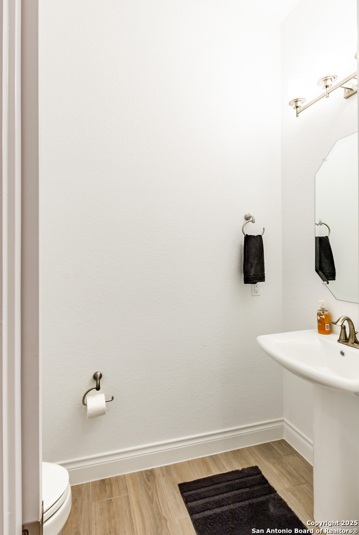 34784 High Gate Road Bulverde, TX 78163 - Photo 13 of 34 a bathroom with a sink and a toilet