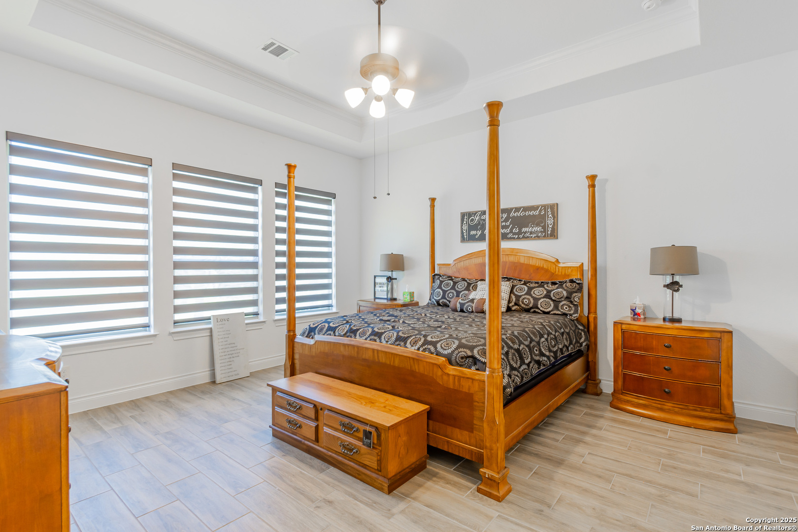 34784 High Gate Road Bulverde, TX 78163 - Photo 14 of 34 a bedroom with a bed and a chandelier