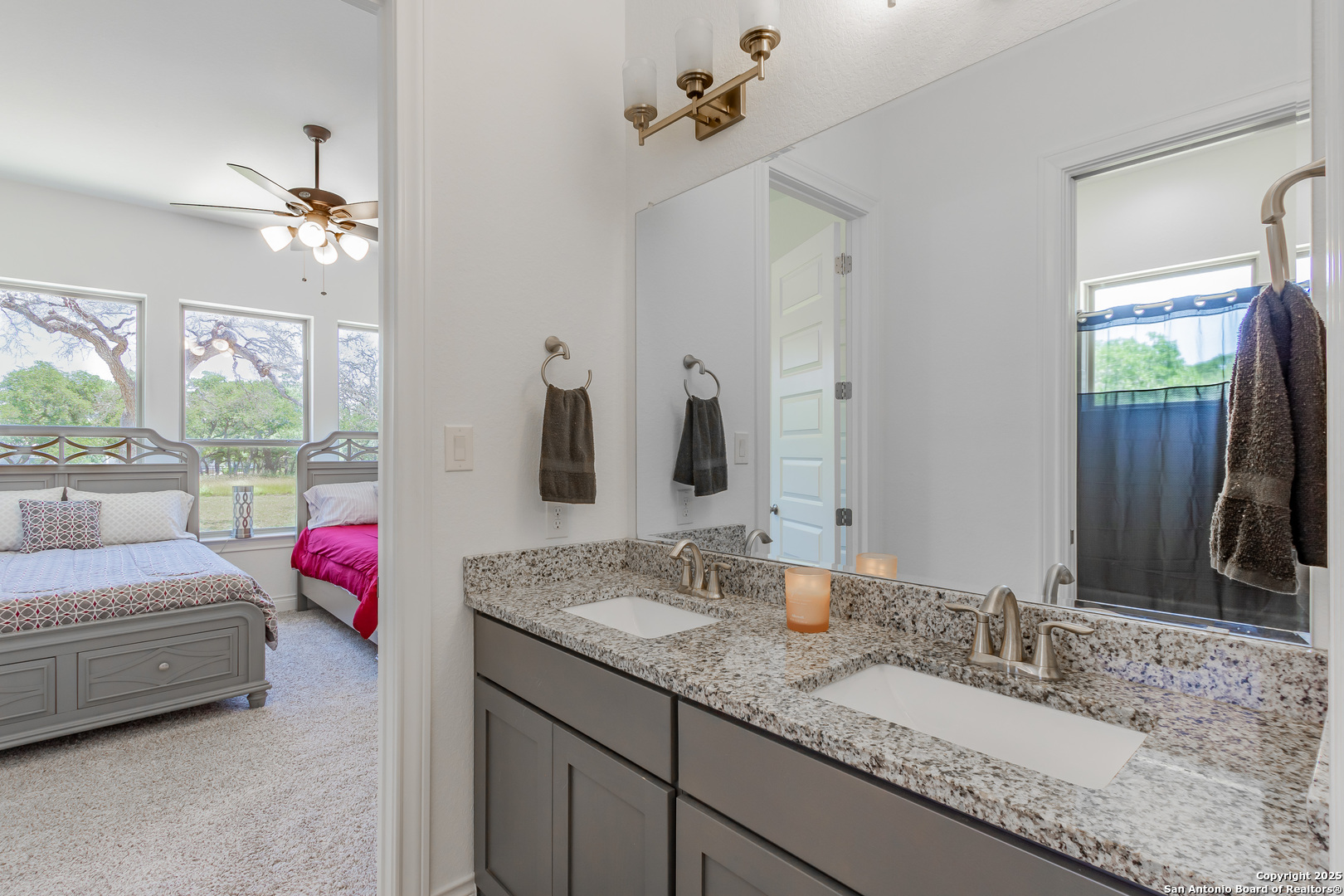 34784 High Gate Road Bulverde, TX 78163 - Photo 22 of 34 a en suite bathroom with a granite countertop sink and a mirror
