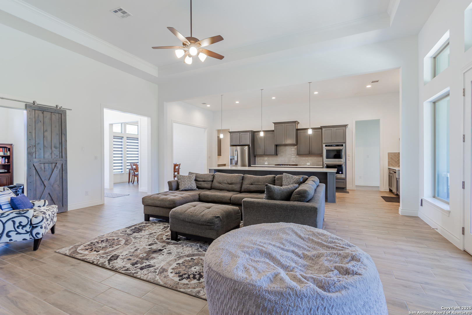 34784 High Gate Road Bulverde, TX 78163 - Photo 9 of 34 a living room with furniture and a chandelier