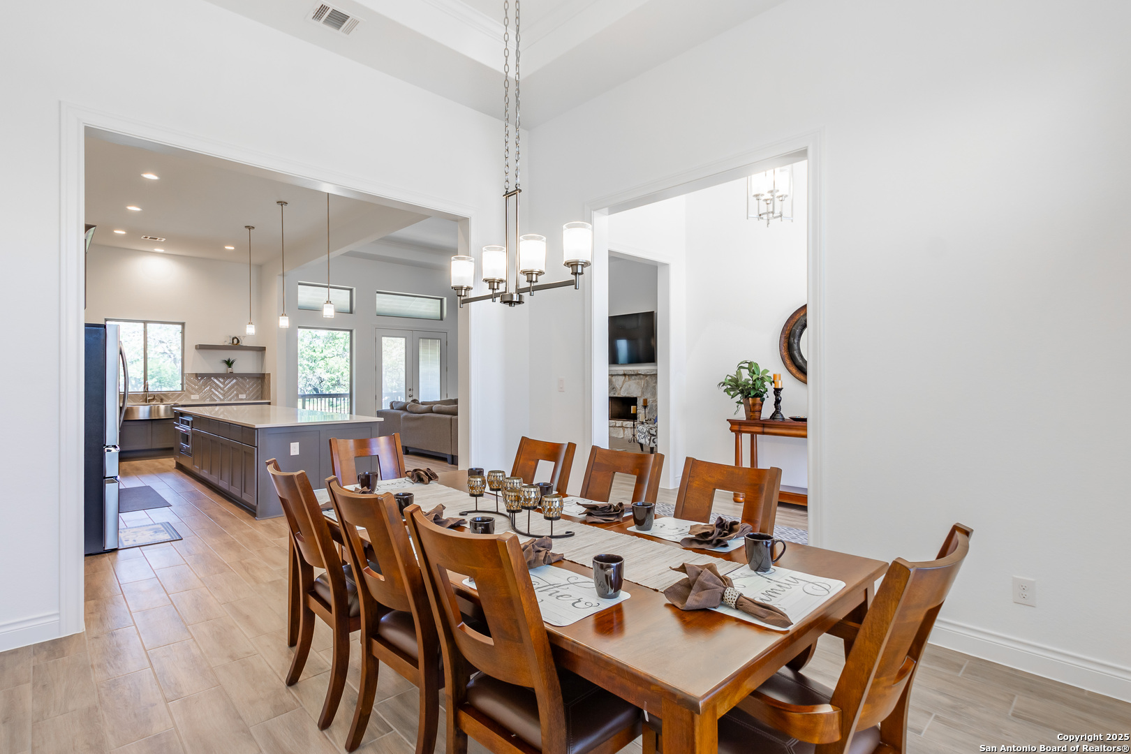 34784 High Gate Road Bulverde, TX 78163 - Photo 10 of 34 a dining room with furniture a chandelier and wooden floor