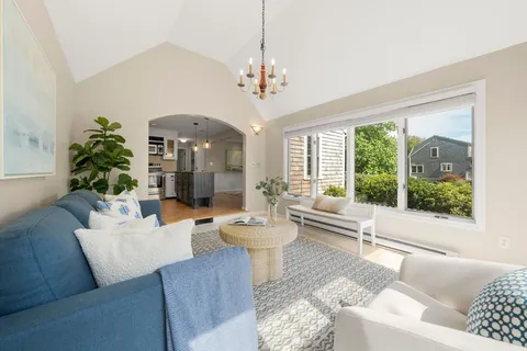 a living room with furniture and a large windows