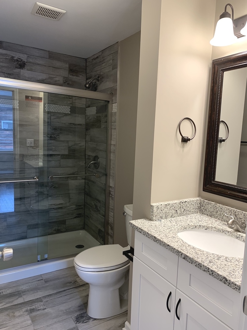 41W910 Burlington Road St. Charles, IL 60175 - Photo 14 of 32 a bathroom with a granite countertop sink a toilet and shower