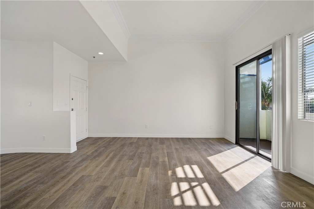 4623 Willis Avenue, Unit 305 Sherman Oaks, CA 91403 - Photo 13 of 74 an empty room with wooden floor and windows