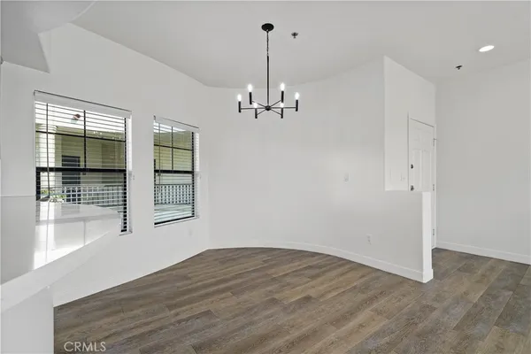 a view of a kitchen with a sink dishwasher a kitchen stove and wooden floor