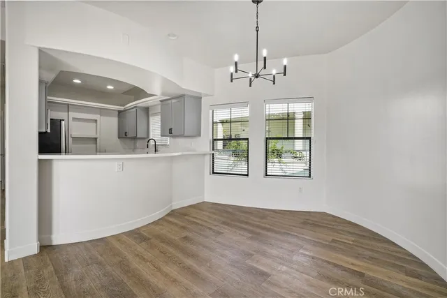 an empty room with windows and a fireplace