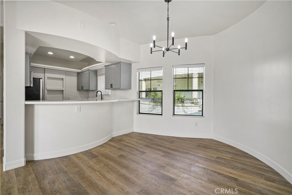 4623 Willis Avenue, Unit 305 Sherman Oaks, CA 91403 - Photo 19 of 74 a view of a kitchen with a sink dishwasher a kitchen stove and wooden floor