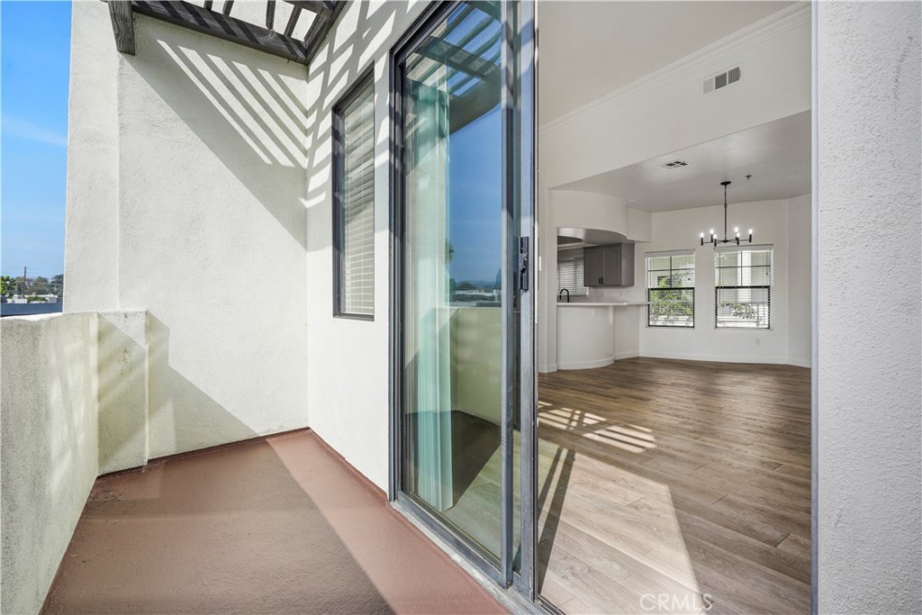 4623 Willis Avenue, Unit 305 Sherman Oaks, CA 91403 - Photo 25 of 74 a view of a living room with a floor to ceiling window and wooden floor