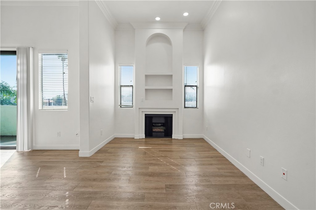 4623 Willis Avenue, Unit 305 Sherman Oaks, CA 91403 - Photo 26 of 74 an empty room with windows and a fireplace