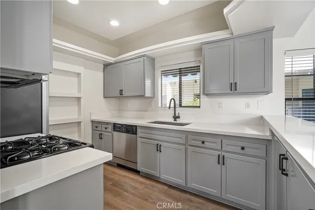 a bathroom with a toilet a sink a mirror and a window