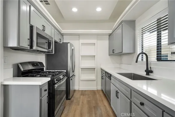 a view of a room with wooden floor