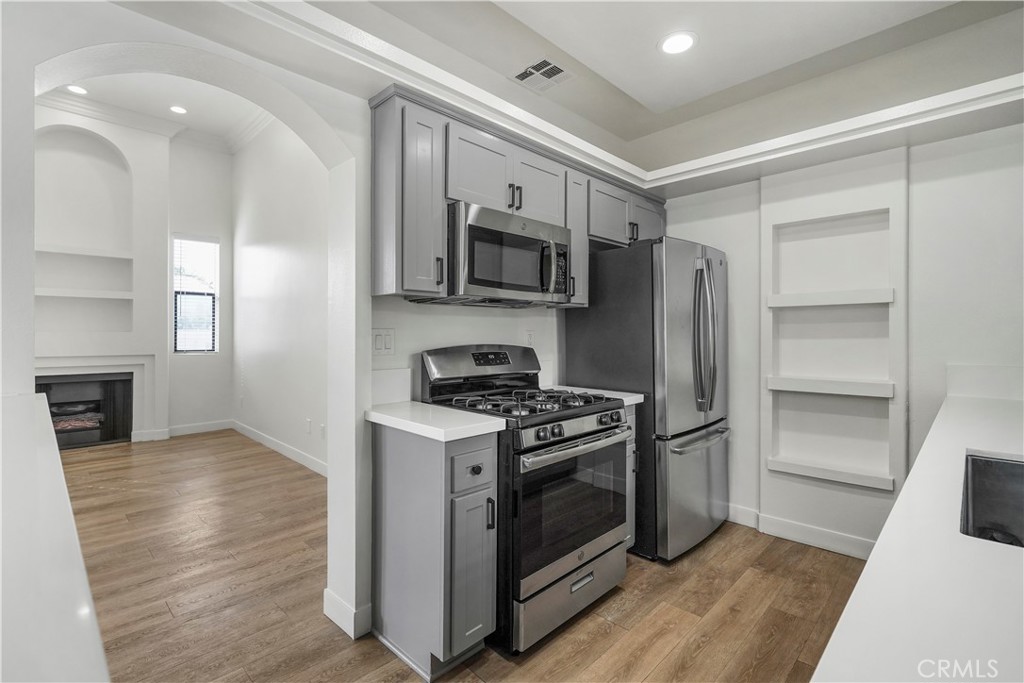 4623 Willis Avenue, Unit 305 Sherman Oaks, CA 91403 - Photo 34 of 74 a kitchen with stainless steel appliances a stove a microwave and a refrigerator