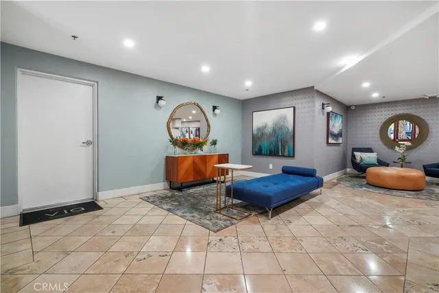 a living room with furniture and a painting on the wall