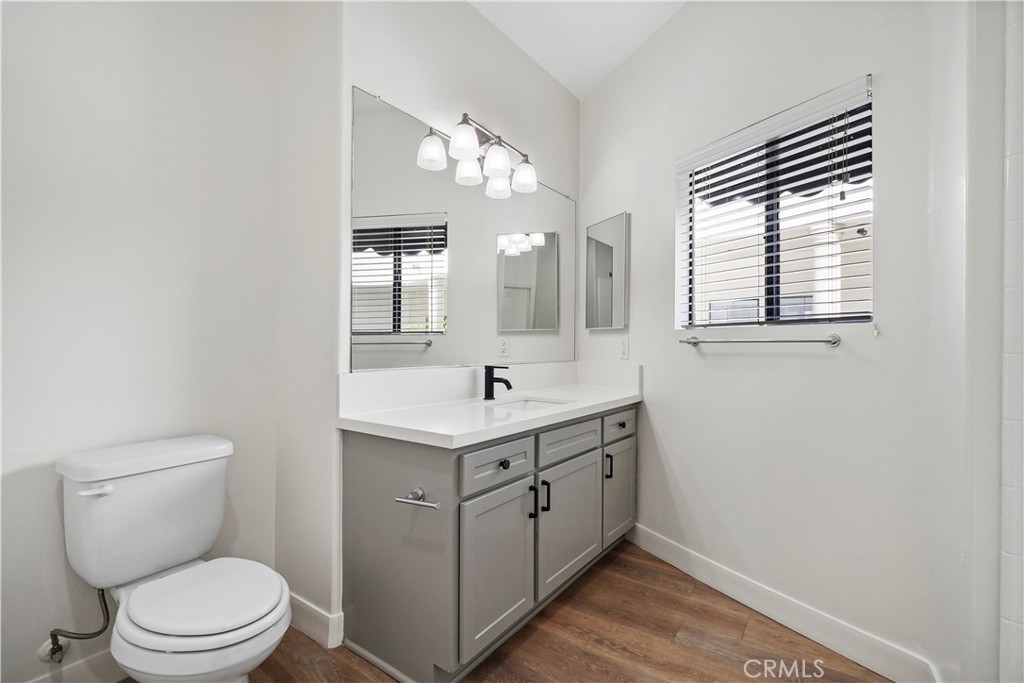 4623 Willis Avenue, Unit 305 Sherman Oaks, CA 91403 - Photo 44 of 74 a bathroom with a toilet a sink a mirror and a window