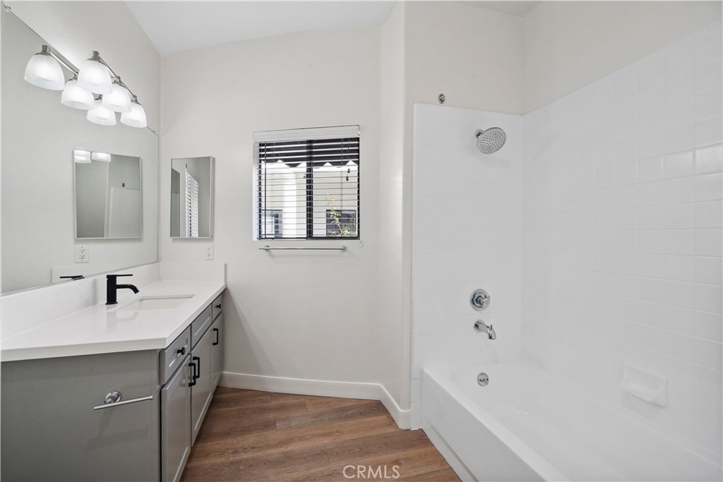 4623 Willis Avenue, Unit 305 Sherman Oaks, CA 91403 - Photo 45 of 74 a bathroom with a double vanity sink a mirror and a bathtub
