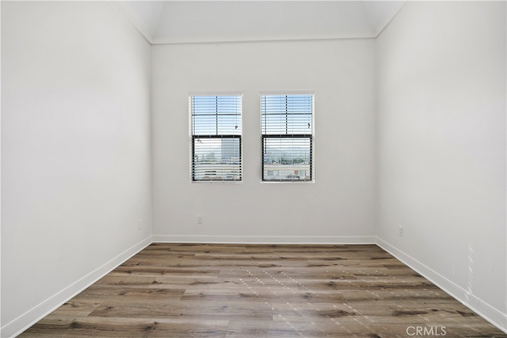 4623 Willis Avenue, Unit 305 Sherman Oaks, CA 91403 - Photo 50 of 74 an empty room with wooden floor and windows