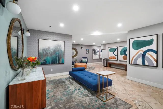 a lobby with furniture and a rug