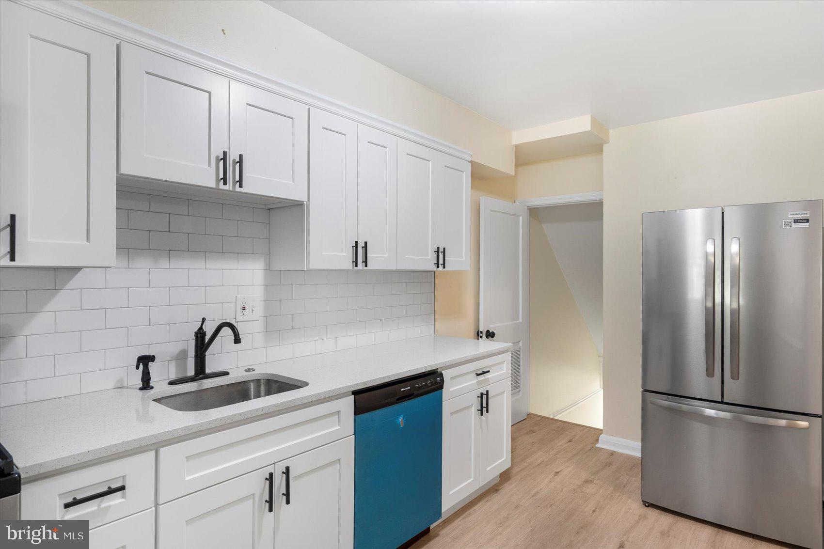 1444 Meridene Drive Baltimore, MD 21239 - Photo 16 of 36 a kitchen with a sink stainless steel appliances and cabinets