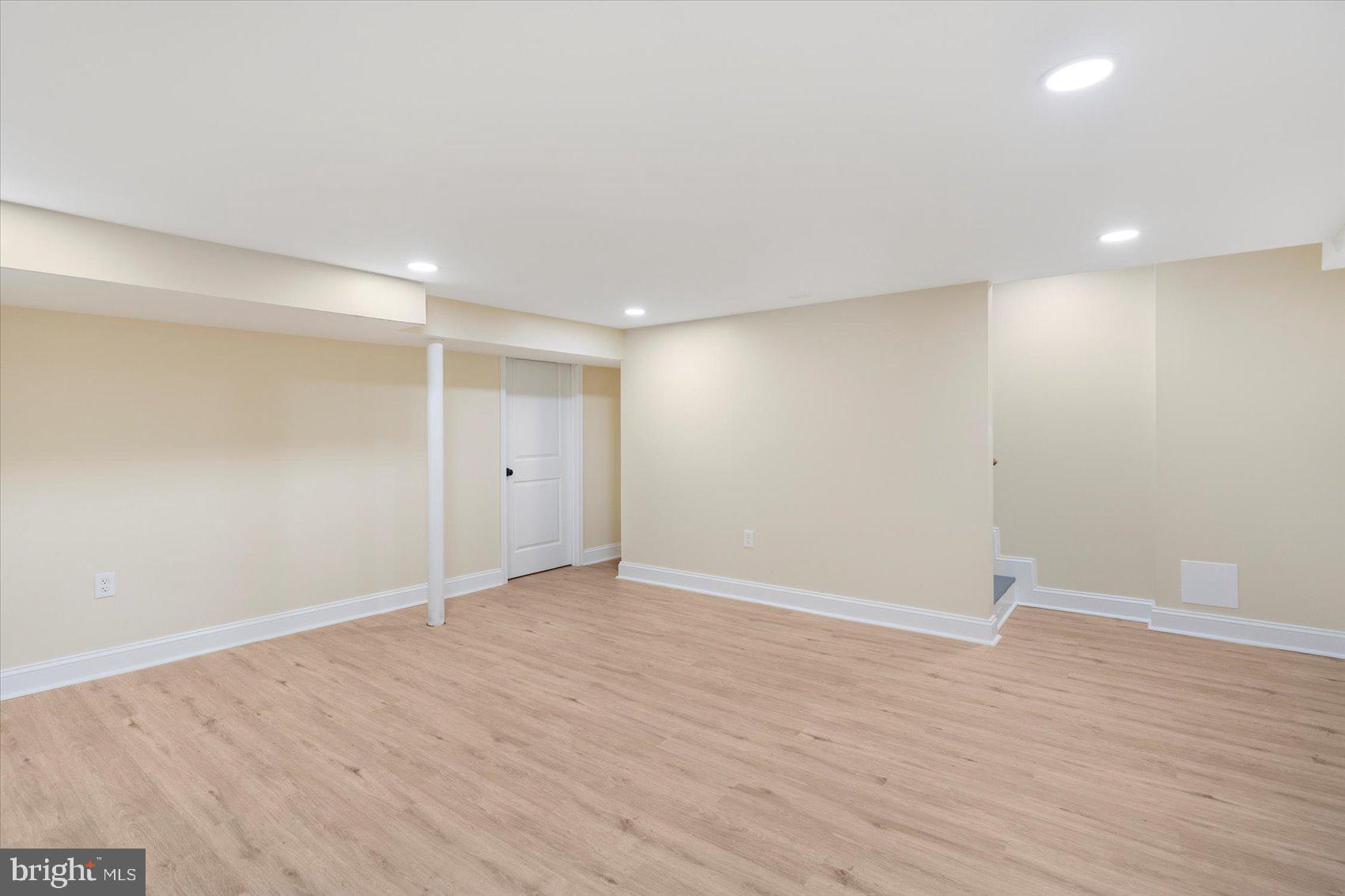1444 Meridene Drive Baltimore, MD 21239 - Photo 18 of 36 a view of an empty room with wooden floor