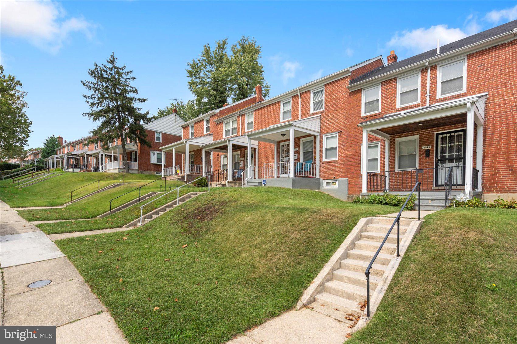 1444 Meridene Drive Baltimore, MD 21239 - Photo 2 of 36 a view of a white house with a big yard and potted plants and a large tree