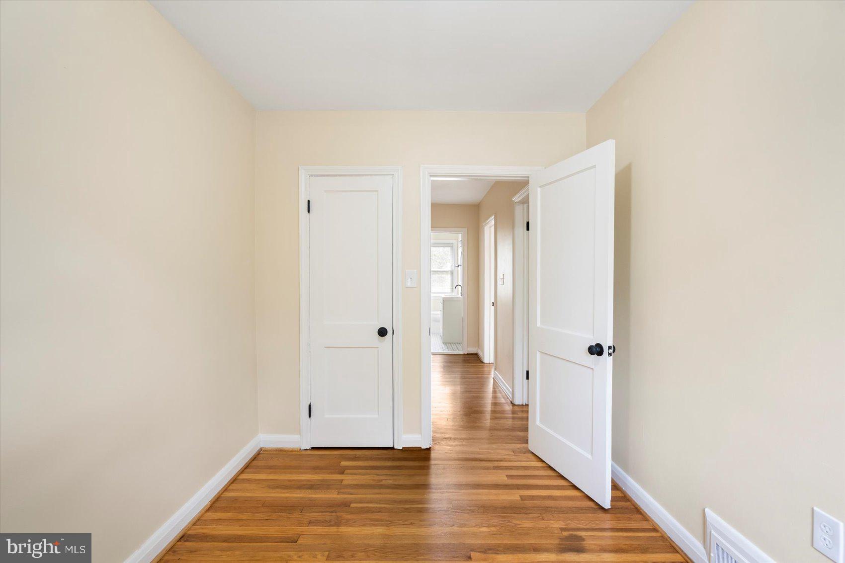 1444 Meridene Drive Baltimore, MD 21239 - Photo 24 of 36 a view of a room with wooden floor and white doors